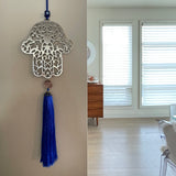 Hamsa wall hanging with blue tassle
